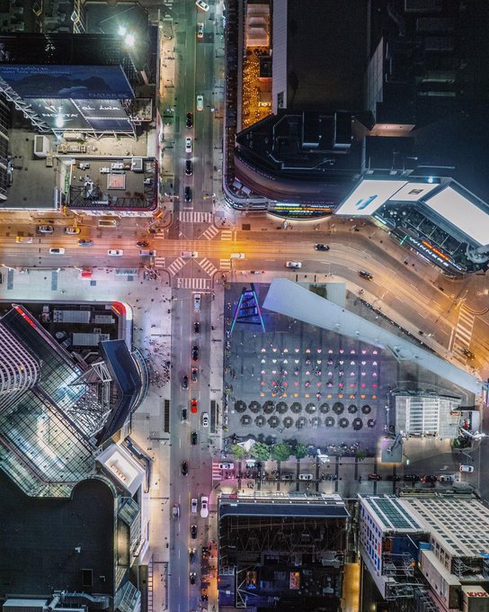 Busy intersection surrounded by buildings and traffic.